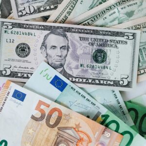 From above of chaotic pile of dollar banknotes and euro cash